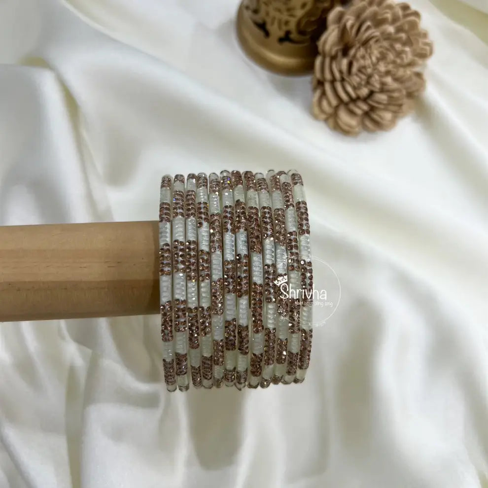 Handcrafted transparent glass bangles featuring sparkling stones