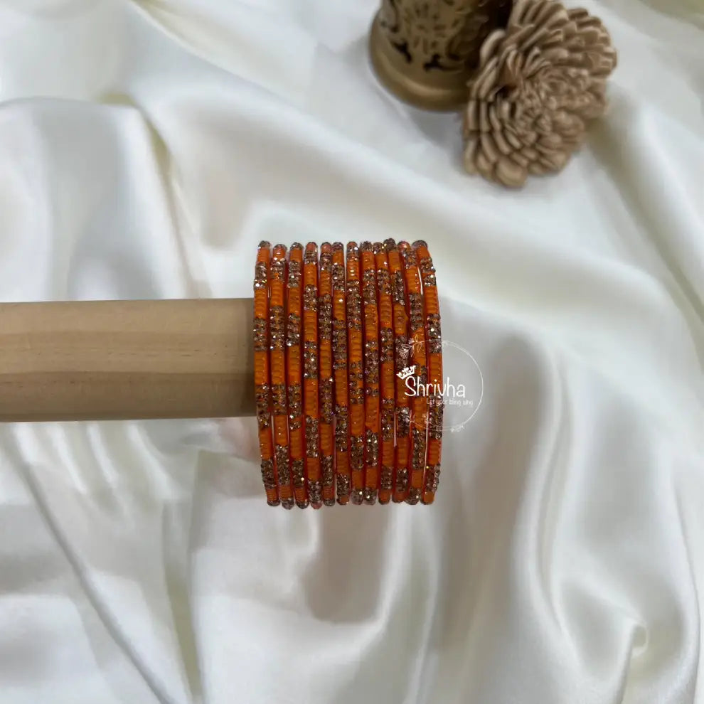 Stack of royal legacy glass bangles featuring intricate stone design